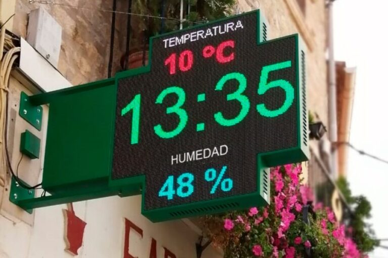 Fachada de una farmacia con una cruz LED visible para atraer la atención de los peatones.